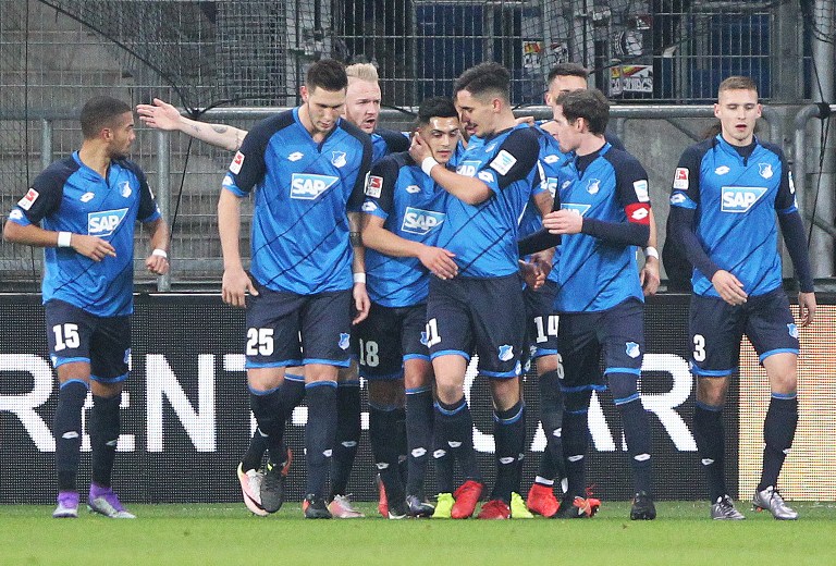 Hoffenheim's players celebrate scoring during the German first division Bundesliga football match between TSG Hoffenheim and BVB Borussia Dortmund at the Wirsol Rhein-Neckar-Arena in Sinsheim, southern Germany, on December 16, 2016. / AFP PHOTO / Amelie QUERFURTH / RESTRICTIONS: DURING MATCH TIME: DFL RULES TO LIMIT THE ONLINE USAGE TO 15 PICTURES PER MATCH AND FORBID IMAGE SEQUENCES TO SIMULATE VIDEO. == RESTRICTED TO EDITORIAL USE == FOR FURTHER QUERIES PLEASE CONTACT DFL DIRECTLY AT + 49 69 650050