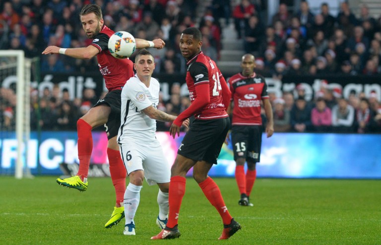 Guingamp's French defender Marcus Coco (R) vies with Paris Saint-Germain's Italian midfielder Marco Verratti (C) during the French L1 football match Guingamp against PSG (Paris Saint Germain) December 17, 2016 at the Roudourou stadium in Guingamp, western of France. / AFP PHOTO / FRED TANNEAU