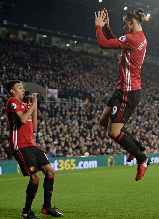 Manchester United's Swedish striker Zlatan Ibrahimovic (R) celebrates with Manchester United's English midfielder Jesse Lingard after scoring the opening goal of the English Premier League football match between West Bromwich Albion and Manchester United at The Hawthorns stadium in West Bromwich, central England, on December 17, 2016. / AFP PHOTO / Oli SCARFF / RESTRICTED TO EDITORIAL USE. No use with unauthorized audio, video, data, fixture lists, club/league logos or 'live' services. Online in-match use limited to 75 images, no video emulation. No use in betting, games or single club/league/player publications. /