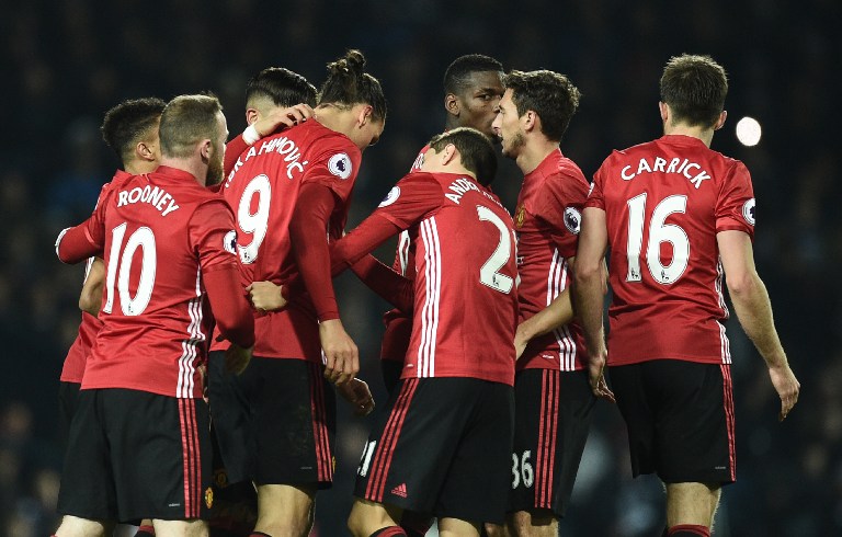 Manchester United's Swedish striker Zlatan Ibrahimovic celebrates with teammates after scoring their second goal during the English Premier League football match between West Bromwich Albion and Manchester United at The Hawthorns stadium in West Bromwich, central England, on December 17, 2016. / AFP PHOTO / Oli SCARFF / RESTRICTED TO EDITORIAL USE. No use with unauthorized audio, video, data, fixture lists, club/league logos or 'live' services. Online in-match use limited to 75 images, no video emulation. No use in betting, games or single club/league/player publications. /