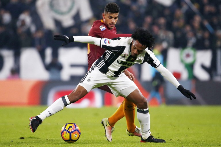 AS Roma's midfielder Gerson of Brazil (L) vies with Juventus' midfielder Juan Cuadrado of Colombia during the Italian Serie A football match Juventus vs As Roma on December 17, 2016 at the 'Juventus Stadium' in Turin.  / AFP PHOTO / MARCO BERTORELLO