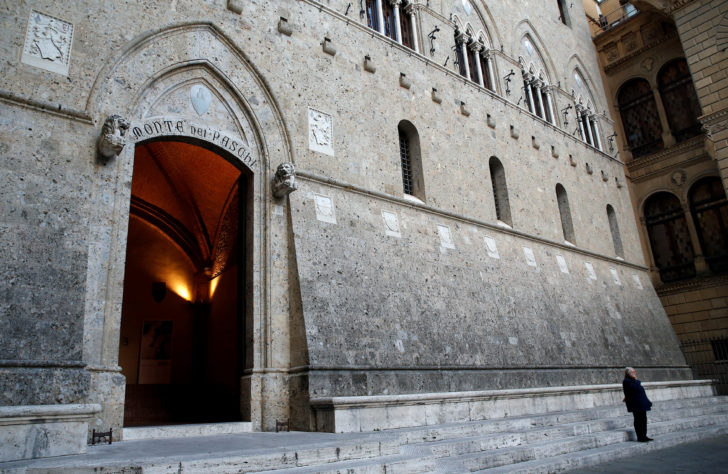 A man makes a phone call near the entrance of the Monte dei Paschi bank headquarters in Siena
