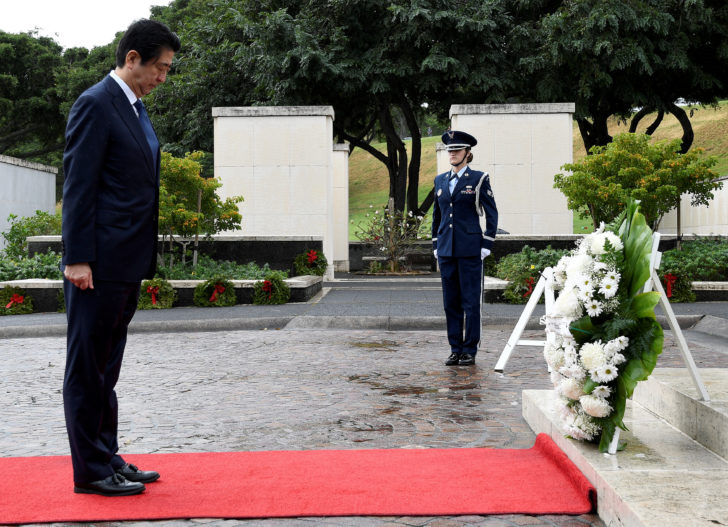 Japanese PM Abe bows his head after presenting wreath at National Memorial Cemetery of the Pacific at Punchbowl in Honolulu, Hawaii, U.S.