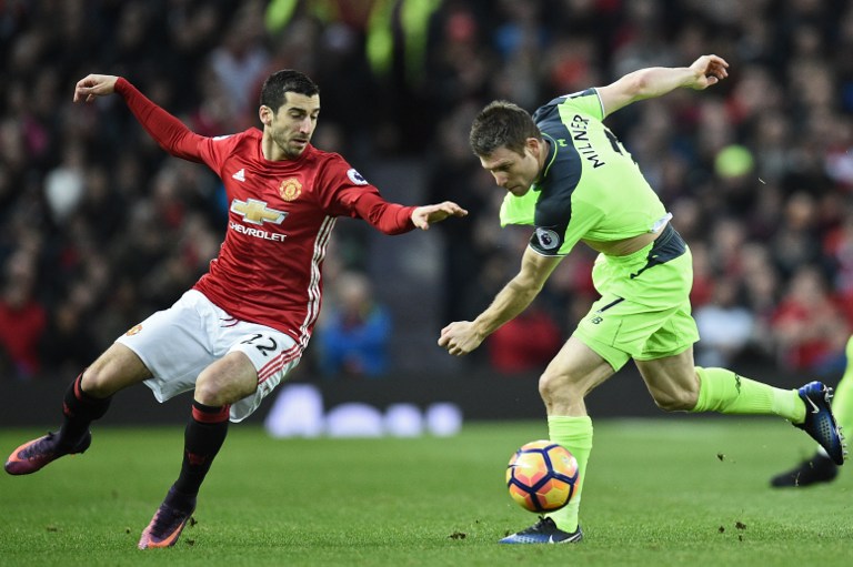 Manchester United's Armenian midfielder Henrikh Mkhitaryan (L) vies with Liverpool's English midfielder James Milner during the English Premier League football match between Manchester United and Liverpool at Old Trafford in Manchester, north west England, on January 15, 2017. / AFP PHOTO / Oli SCARFF / RESTRICTED TO EDITORIAL USE. No use with unauthorized audio, video, data, fixture lists, club/league logos or 'live' services. Online in-match use limited to 75 images, no video emulation. No use in betting, games or single club/league/player publications. /
