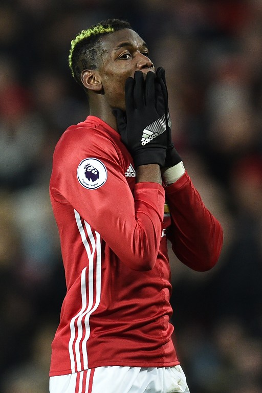 Manchester United's French midfielder Paul Pogba reacts after missing a chance to score during the English Premier League football match between Manchester United and Liverpool at Old Trafford in Manchester, north west England, on January 15, 2017. / AFP PHOTO / Oli SCARFF / RESTRICTED TO EDITORIAL USE. No use with unauthorized audio, video, data, fixture lists, club/league logos or 'live' services. Online in-match use limited to 75 images, no video emulation. No use in betting, games or single club/league/player publications. /
