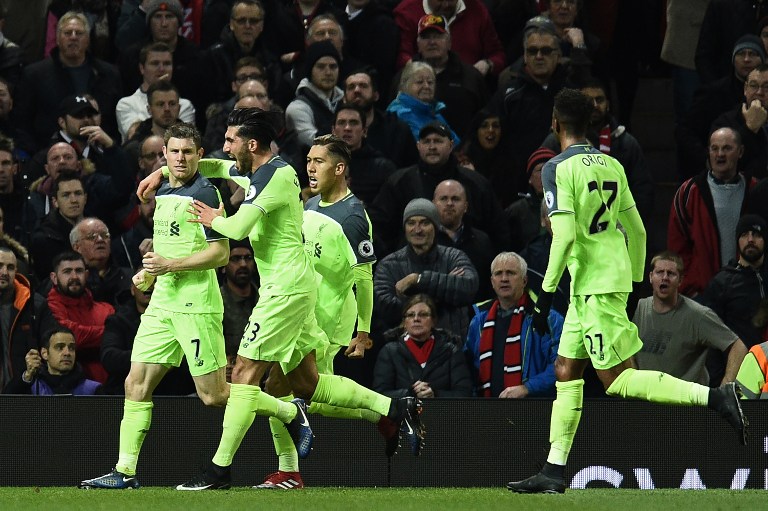Liverpool's English midfielder James Milner (L) celebrates scoring his team's first goal from the penalty spot during the English Premier League football match between Manchester United and Liverpool at Old Trafford in Manchester, north west England, on January 15, 2017. / AFP PHOTO / Oli SCARFF / RESTRICTED TO EDITORIAL USE. No use with unauthorized audio, video, data, fixture lists, club/league logos or 'live' services. Online in-match use limited to 75 images, no video emulation. No use in betting, games or single club/league/player publications. /