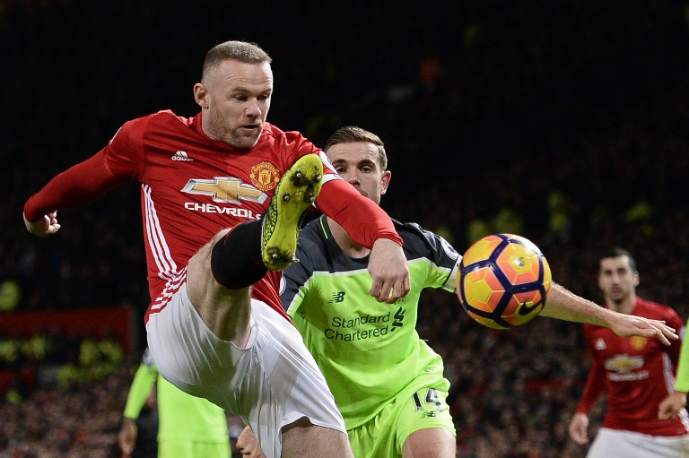 Manchester United's English striker Wayne Rooney (L) vies with Liverpool's English midfielder Jordan Henderson during the English Premier League football match between Manchester United and Liverpool at Old Trafford in Manchester, north west England, on January 15, 2017. / AFP PHOTO / Oli SCARFF / RESTRICTED TO EDITORIAL USE. No use with unauthorized audio, video, data, fixture lists, club/league logos or 'live' services. Online in-match use limited to 75 images, no video emulation. No use in betting, games or single club/league/player publications. /