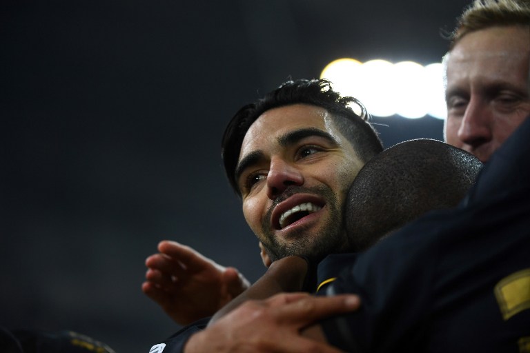 Monaco's Be Mota Veiga de Carvalho E Silva (hidden) is congratulated by Monaco's forward Falcao after scoring a goal during the French L1 football match Marseille vs Monaco on January 15, 2017 at the Velodrome stadium in Marseille, southern France.  / AFP PHOTO / ANNE-CHRISTINE POUJOULAT