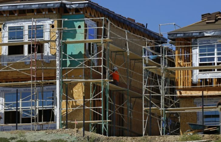 A worker works at the construction site of a new home in Carlsbad