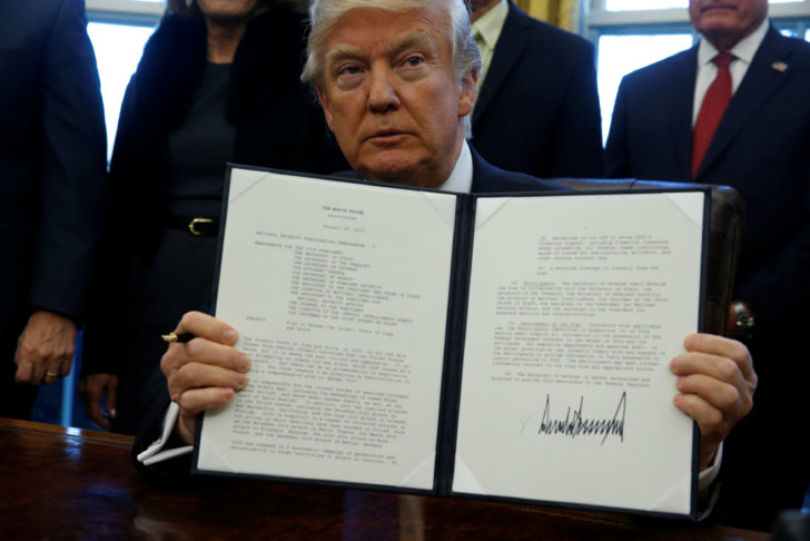 Trump signs a memorandum to security services directing them to defeat the Islamic State in the Oval Office at the White House in Washington