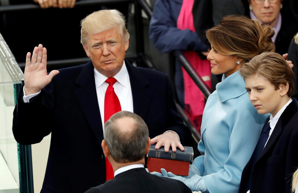 US President Donald Trump takes the oath of office with his wife Melania and son Barron at his side, during his inauguration at the U.S. Capitol in Washington, U.S., January 20, 2017. REUTERS/Kevin Lamarque     TPX IMAGES OF THE DAY