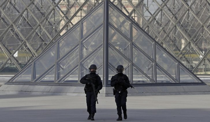 French police secure the site near the Louvre Pyramid in Paris