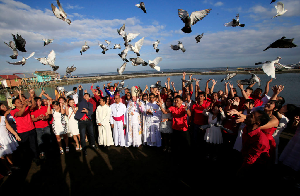 Newly-wed couples release pigeons after their mass wedding as part of Valentine's Day celebration in Rosario town, Cavite city, south of Manila, Philippines February 14, 2017. REUTERS/Romeo Ranoco