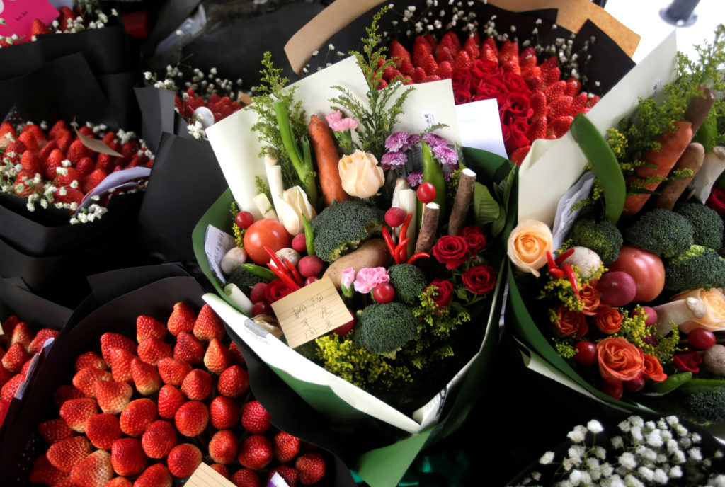 Bouquets made of vegetables, strawberries and flowers are seen in a vehicle as a delivery staff of a florist prepares to deliver them for clients on Valentine's Day in Beijing, China, February 14, 2017. REUTERS/Jason Lee TPX IMAGES OF THE DAY