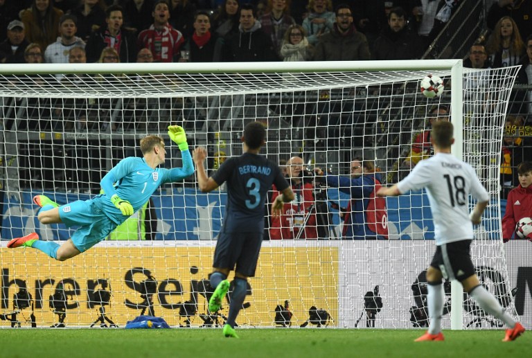 England's goalkeeper Joe Hart misses the goal by Germany's midfielder Lukas Podolski (unseen) during a friendly football match between Germany and England on March 22, 2017 in Dortmund, western Germany. It is Lukas Podolski's last match with the German team. / AFP PHOTO / dpa / Bernd Thissen / Germany OUT