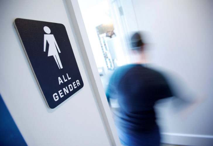 FILE PHOTO - A bathroom sign welcomes both genders at the Cacao Cinnamon coffee shop in Durham North Carolina