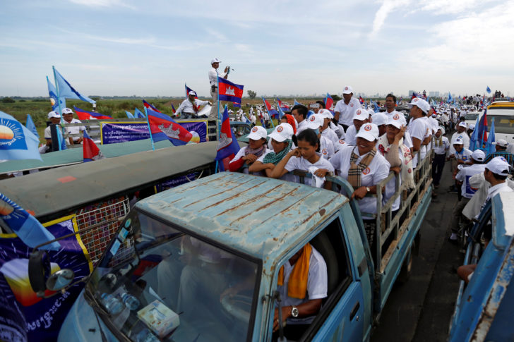 Supporters of the Cambodian People's Party stand on a truck as they are surrounded by supporters of the CNRP during a local election campaign in Phnom Penh