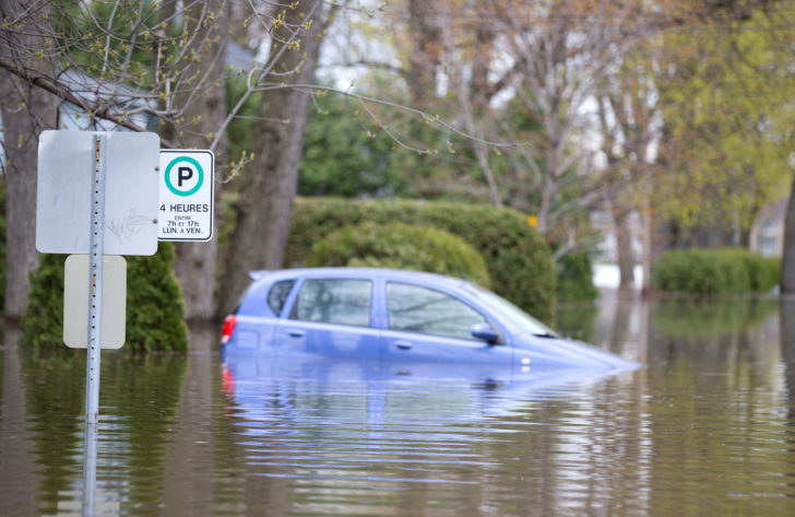 Car is stranded in flooded neighbourhood in Deux-Montagnes