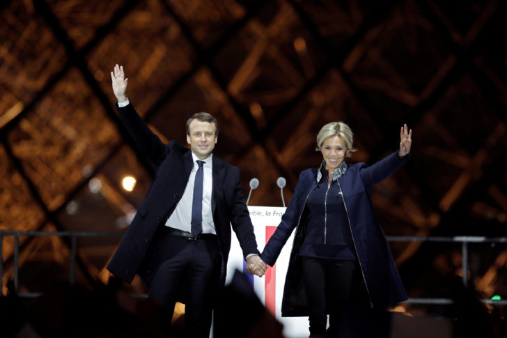 French President elect Emmanuel Macron and his wife Brigitte Trogneux celebrate on the stage at his victory rally near the Louvre in Paris