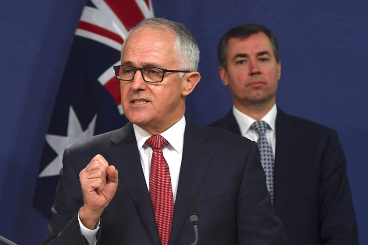 Australian Prime Minister Malcolm Turnbull speaks as Australia's Minister for Justice Michael Keenan listens on during a media conference in Sydney, Australia