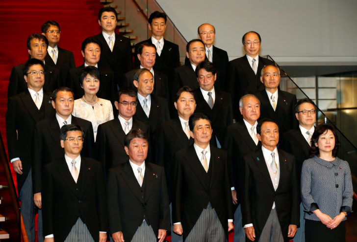 Japan's Prime Minister Shinzo Abe poses with his cabinet ministers as they attend a photo session at Abe's official residence in Tokyo