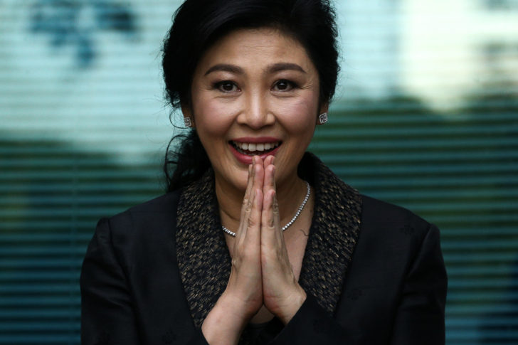 FILE PHOTO: Ousted former Thai prime minister Yingluck Shinawatra greets supporters as she arrives at the Supreme Court in Bangkok