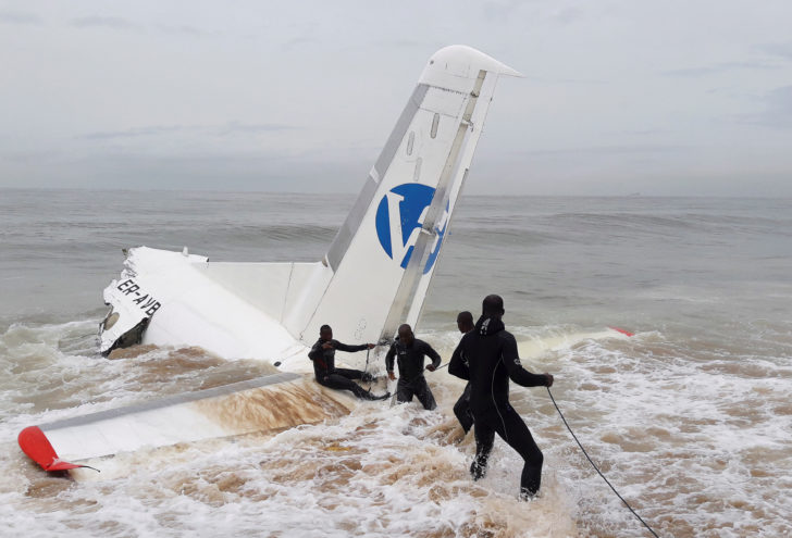 Rescuers pull the wreckage of a propeller-engine cargo plane after it crashed in the sea near the international airport in Ivory Coast's main city, Abidjan