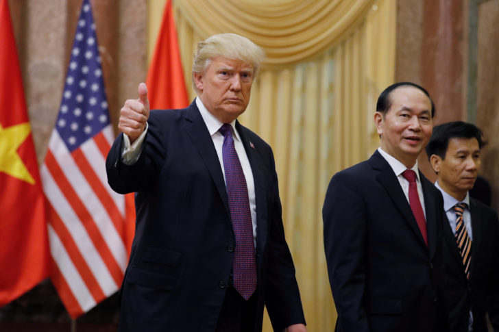 U.S. President Donald Trump gives a thumbs up next to Vietnam's President Tran Dai Quang upon his arrival at the Presidential Palace in Hanoi