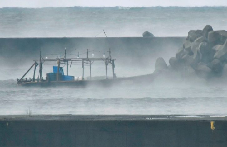 A wooden boat is seen in front of a breakwater in Yurihonjo, Japan