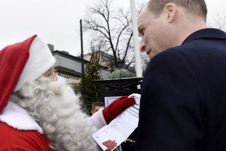 Britain's Prince William, Duke of Cambridge, presents Prince George's handwritten Christmas wish list to Santa Claus, during his visit to the Esplanade Park and winter fair Manta's Market in Helsinki