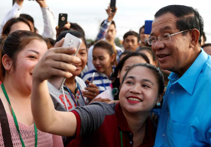 A garment worker takes a selfie with Cambodia's Prime Minister Hun Sen on the outskirts of Phnom Penh