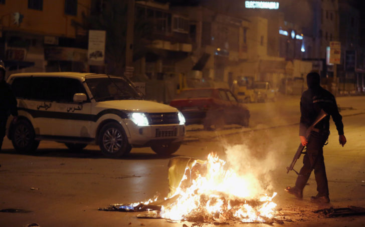 Riot police clash with protesters during demonstrations against rising prices and tax increases, in Tunis