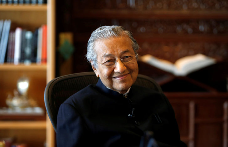 FILE PHOTO: Former Malaysian prime minister Mahathir smiles during an interview with Reuters in Putrajaya