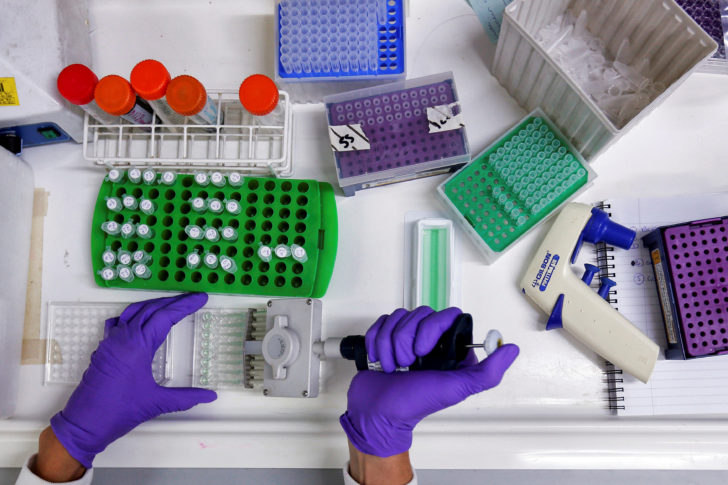 FILE PHOTO: Scientist prepares protein samples for analysis in a lab at the Institute of Cancer Research in Sutton, Britain.