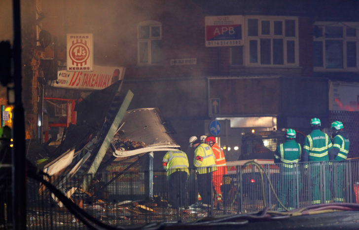 Members of the emergency services work at the site of an explosion which destroyed a convenience store and a home in Leicester