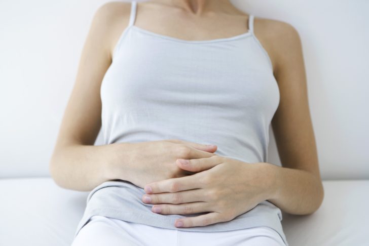 woman-holding-stomach--cropped-view-90246246-59847d44396e5a0011f08b05