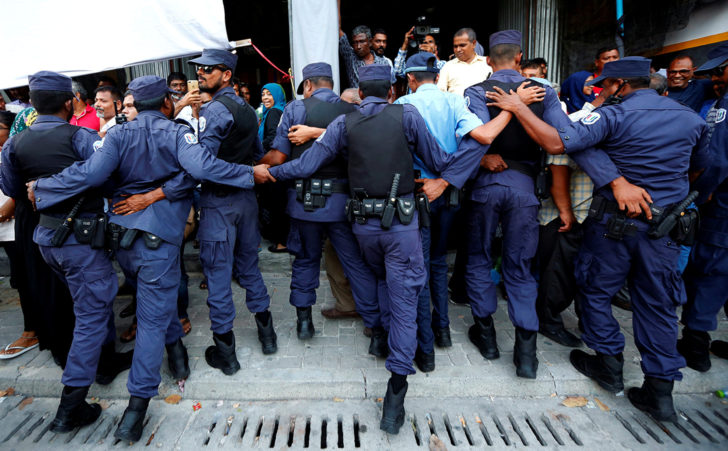 FILE PHOTO: Maldivian Police officers push back opposition supporters near the main opposition Maldives Democratic Party (MDP) headquarters during a protest demanding the government to release jailed opposition leaders, in Male