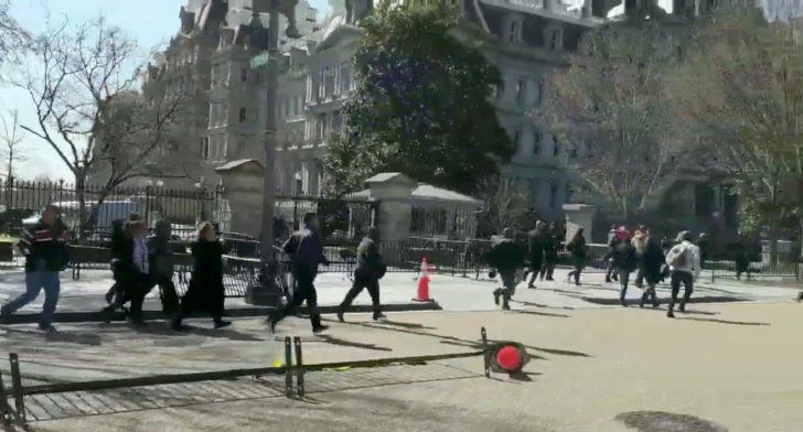 People run away from a site where an unidentified man was wounded in shooting near the White House, in Washington