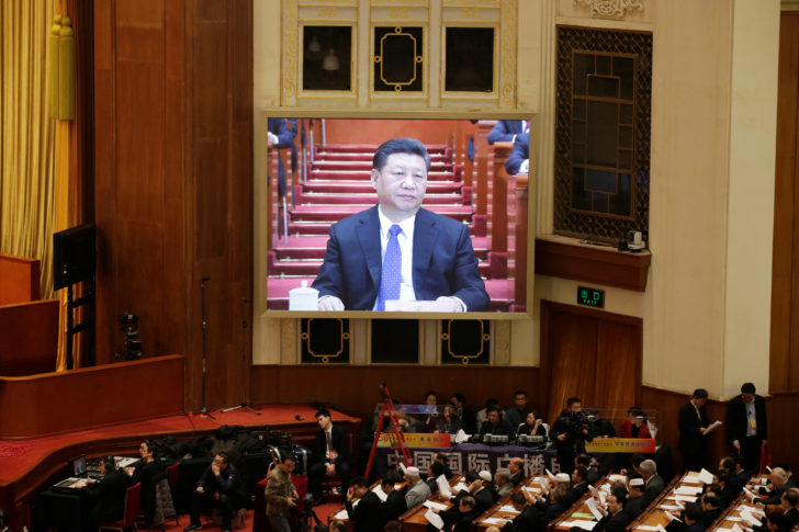 Chinese President Xi Jinping is seen on a giant screen at the opening session of the CPPCC at the Great Hall of the People in Beijing
