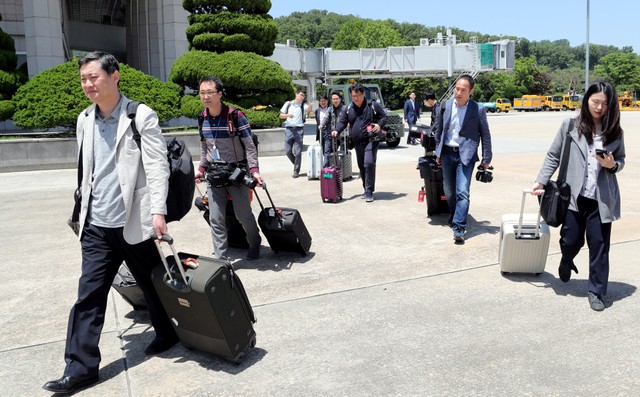 Members of a South Korean media group leave for the Wonsan airport, at Seoul Air Base in Seongnam