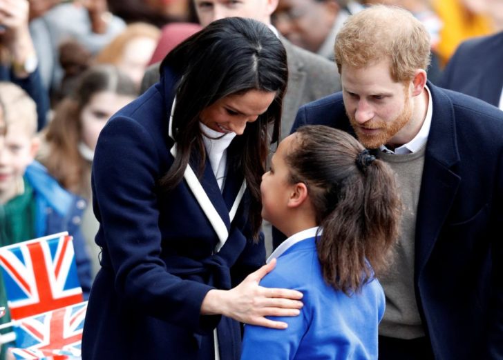 Britain's Prince Harry and his fiancee Meghan Markle meet local school children during a wakabout on a visit to Birmingham