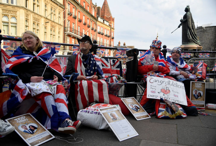 Royal fans hold their spaces after sleeping on the pavement outside of Windsor Castle, the location for the forthcoming wedding of Britain's Prince Harry and his fiancee Meghan Markle, in Windsor, Britain