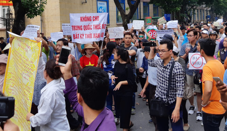 Protesters hold a banner which reads