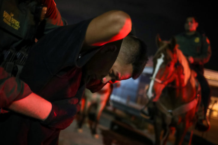 Border Patrol agents on horses apprehend a man who illegally crossed into the U.S. from Mexico in Sunland Park, New Mexico