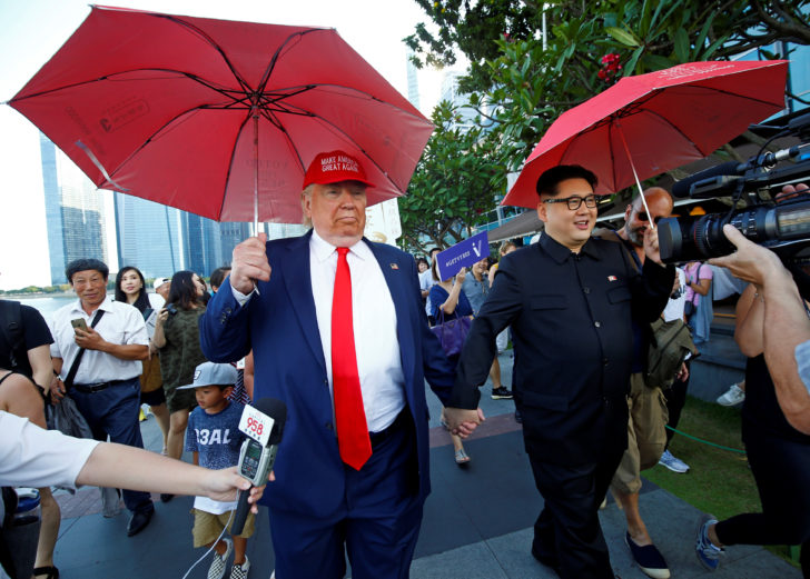 Howard, an Australian-Chinese impersonating North Korean leader Kim Jong-un, and Dennis Alan, impersonating U.S. President Donald Trump, meet at Merlion Park in Singapore