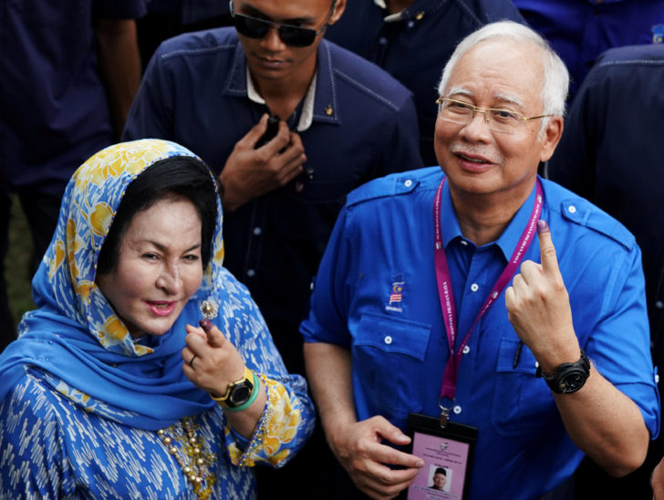 FILE PHOTO: Malaysia's Prime Minister Najib Razak and his wife Rosmah Mansor show their ink-stained fingers after voting in Malaysia's general election in Pekan