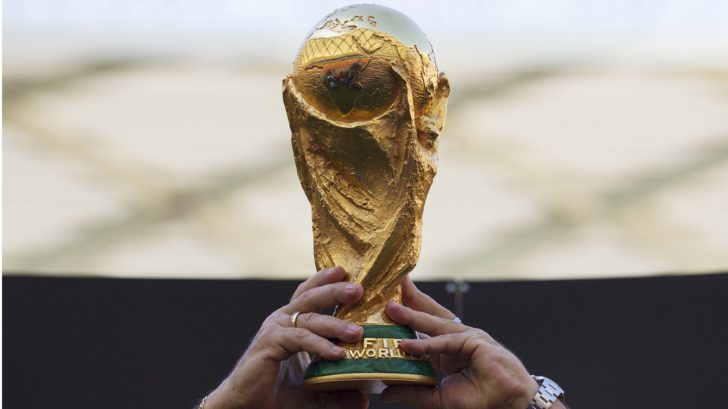 Brazil's Rivelino holds the World Cup trophy in Manaus