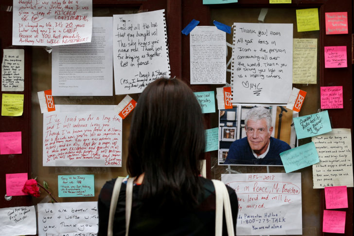 A woman looks at tributes to chef and television personality Anthony Bourdain outside Brasserie Les Halles in New York