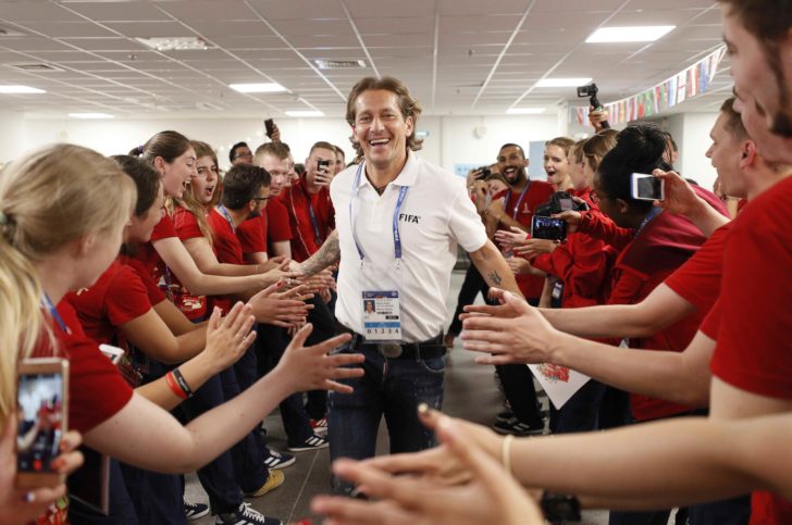 Former player of the Spanish national soccer team Salgado greets World Cup volunteers during an event in Moscow