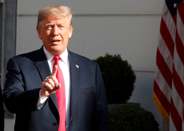 U.S. President Donald Trump gestures as he is greeted by NATO Secretary General Jens Stoltenberg before a bilateral breakfast ahead of the NATO Summit in Brussels